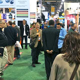 Photo of convention floor and attendees 
                    representative of the meetings for which MSI provides security.